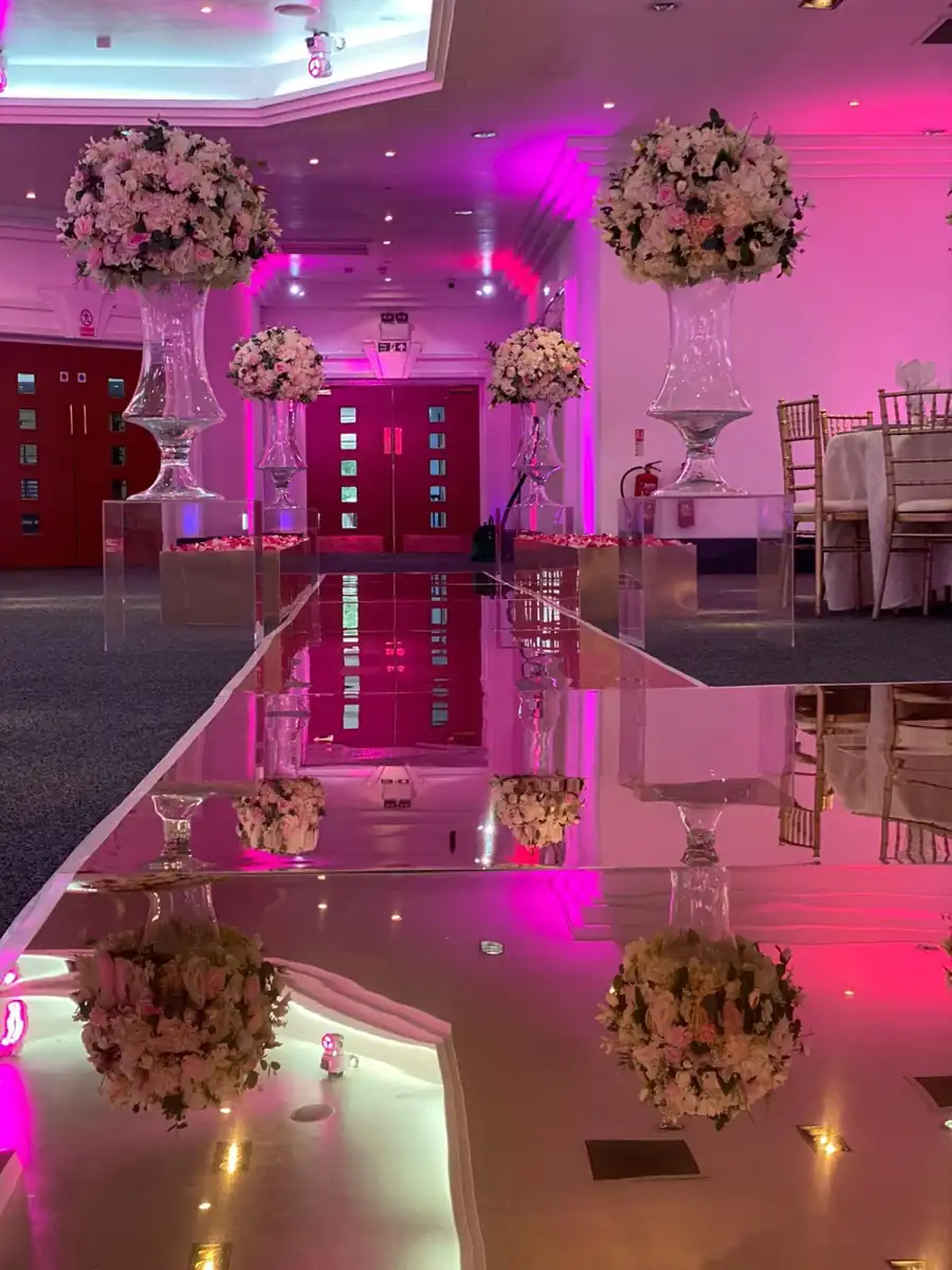 Pink floral aisle and mirrored walkway