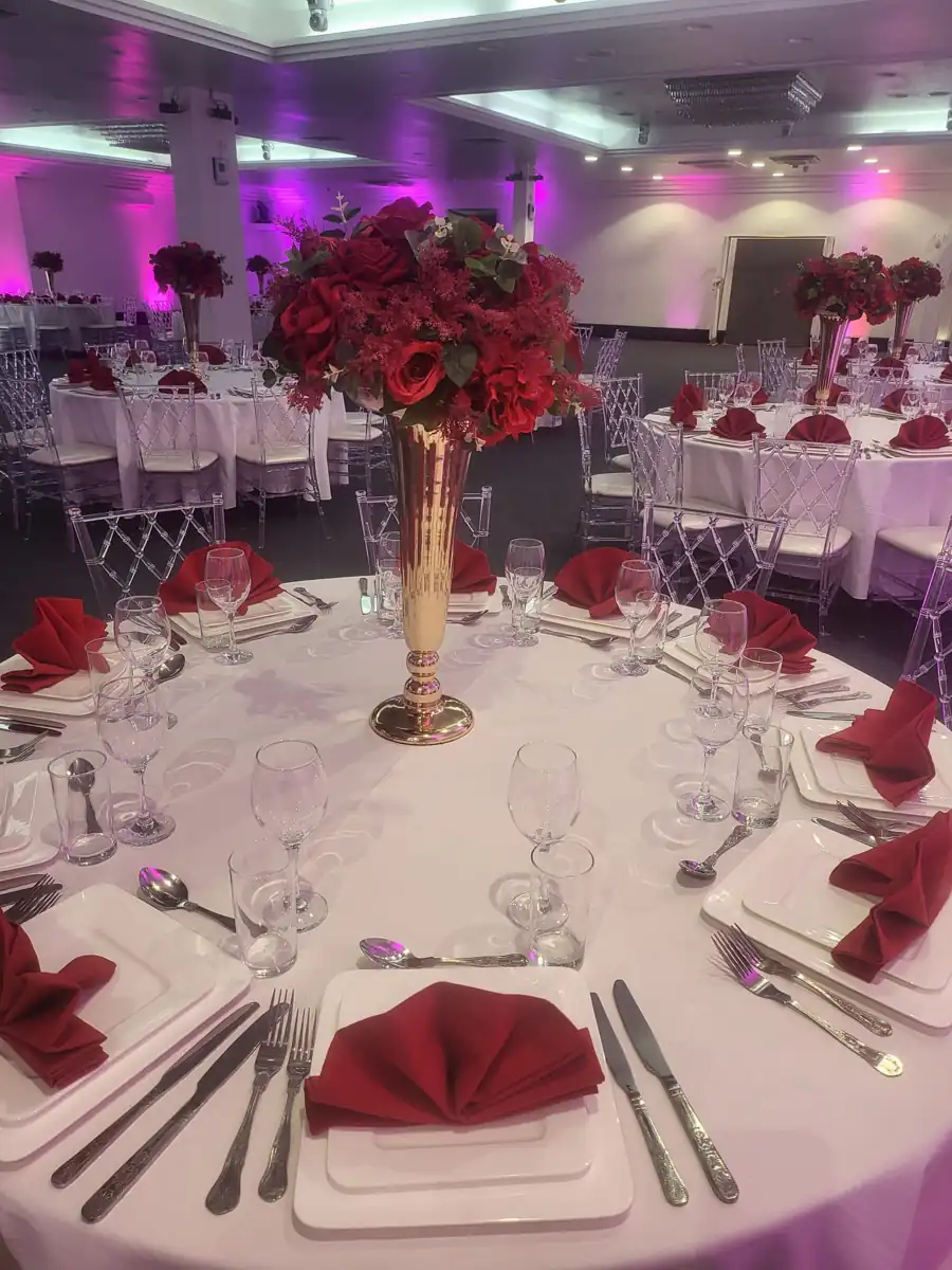 Red floral centrepiece and banquet place settings