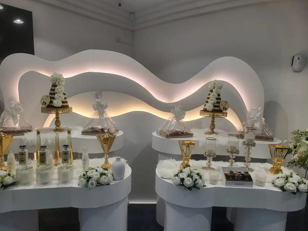 Sculpted white wedding stage and floral arrangements