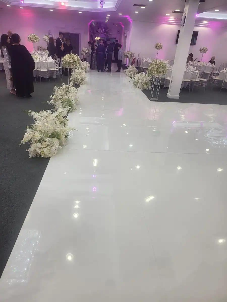 White wedding aisle lined with flowers