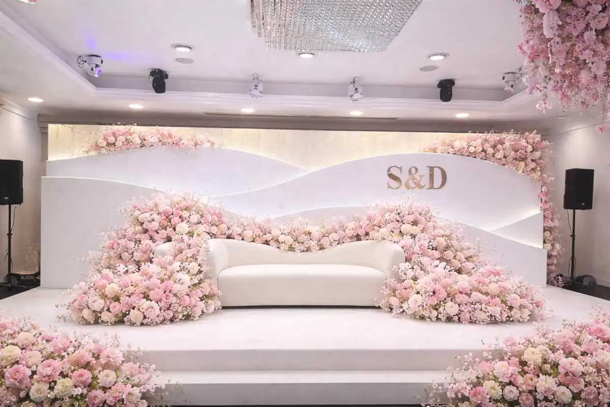 Blush flowers and an elegantly dressed wedding stage