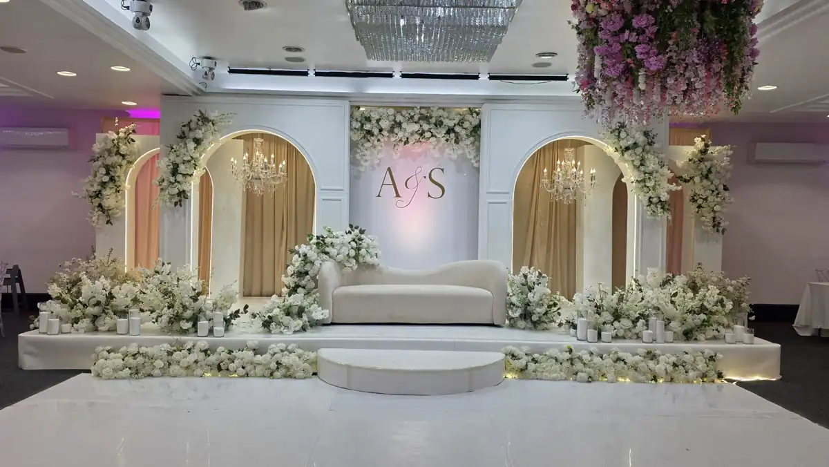 Gold arches and white floral wedding stage