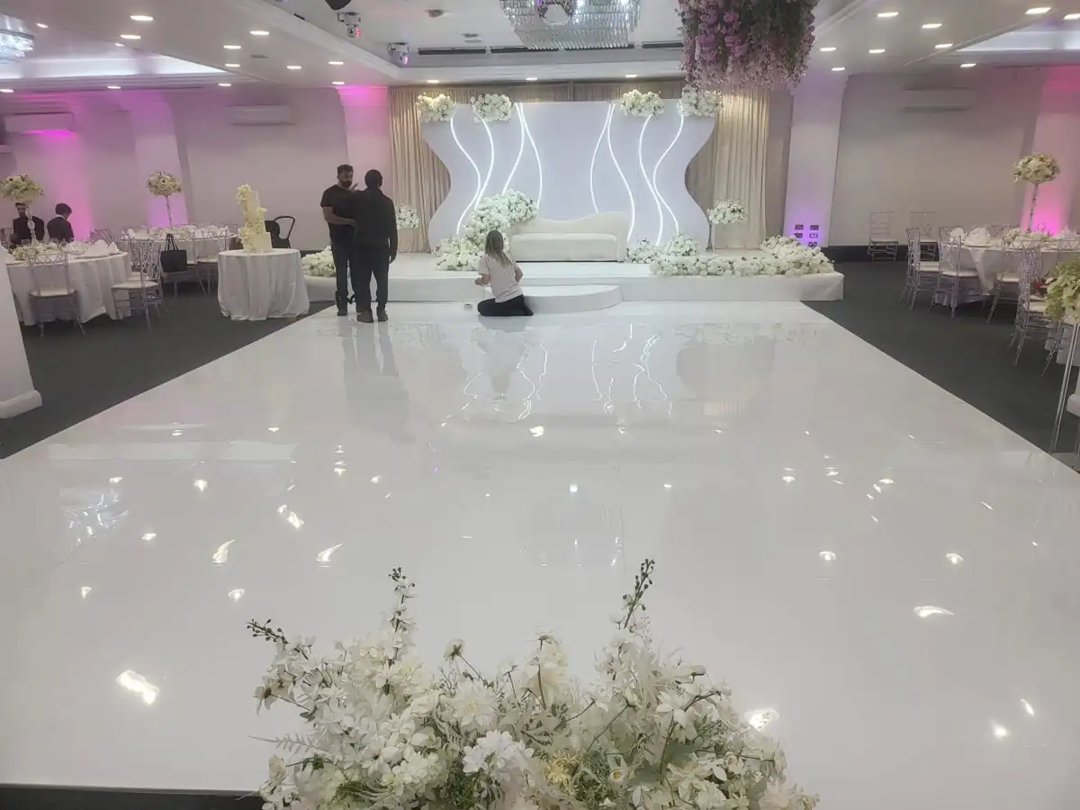 Hall arranged around a white dance floor