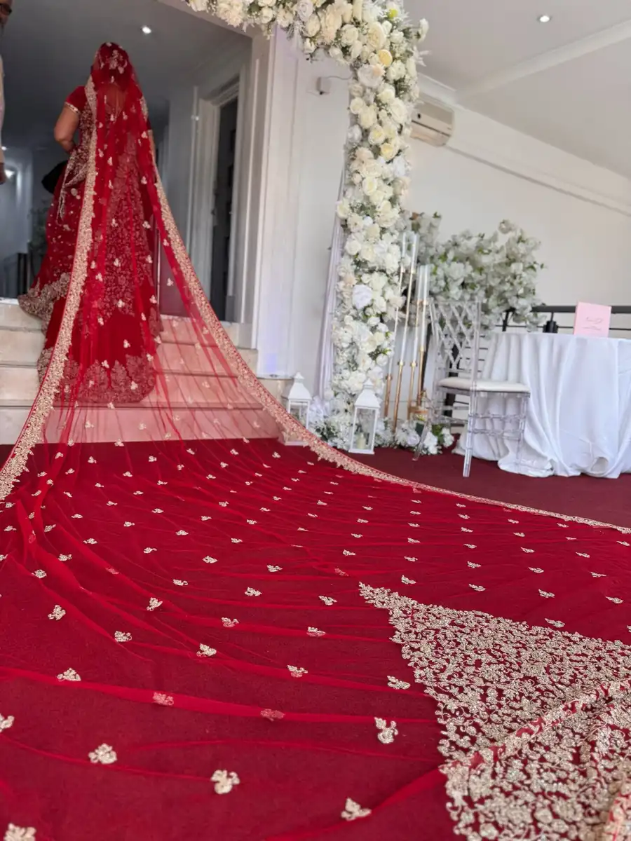 Red bridal veil and floral wedding details